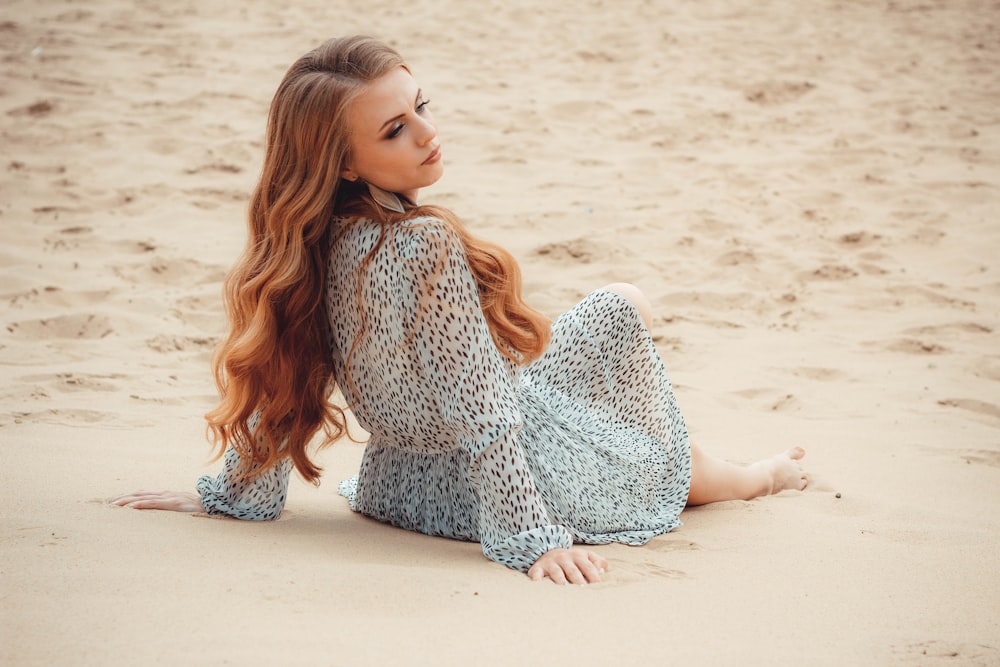 woman sitting on sand