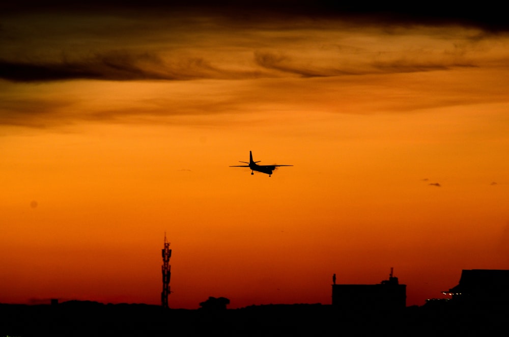 silhouette of airliner during golden hour