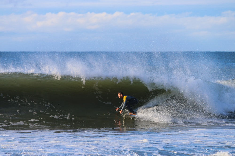 man surfing at the ocean during day