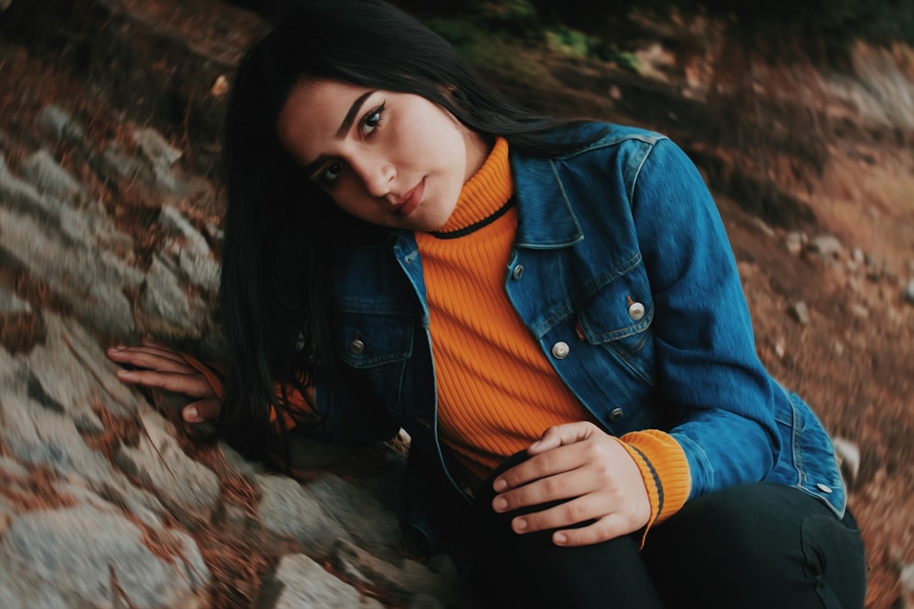 shallow focus photo of woman in blue denim button-up jacket