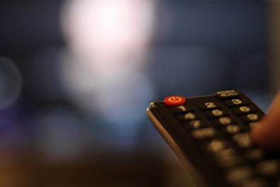 Close-up of a television receiver with remote control
