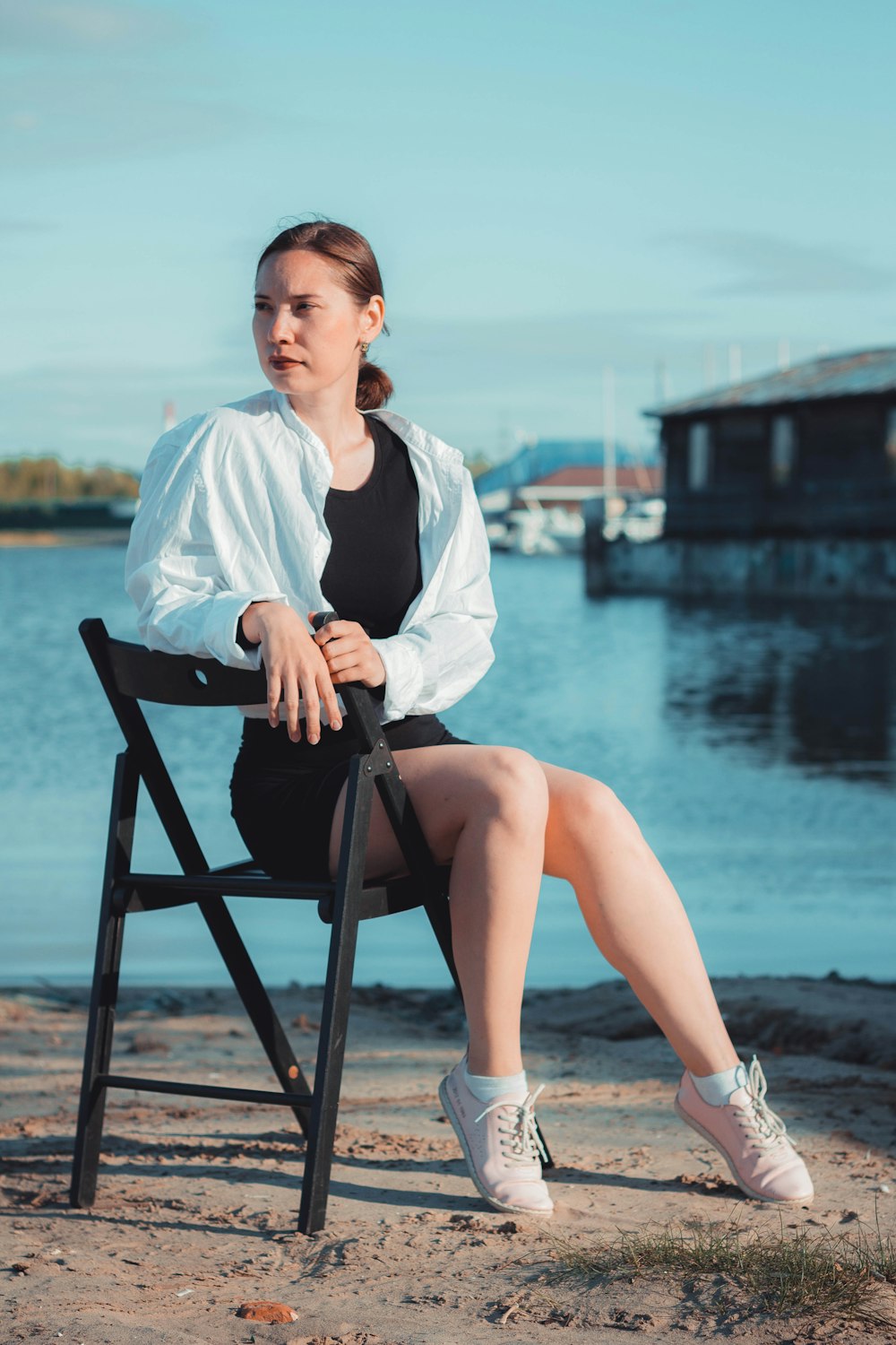 woman sitting on chair near water