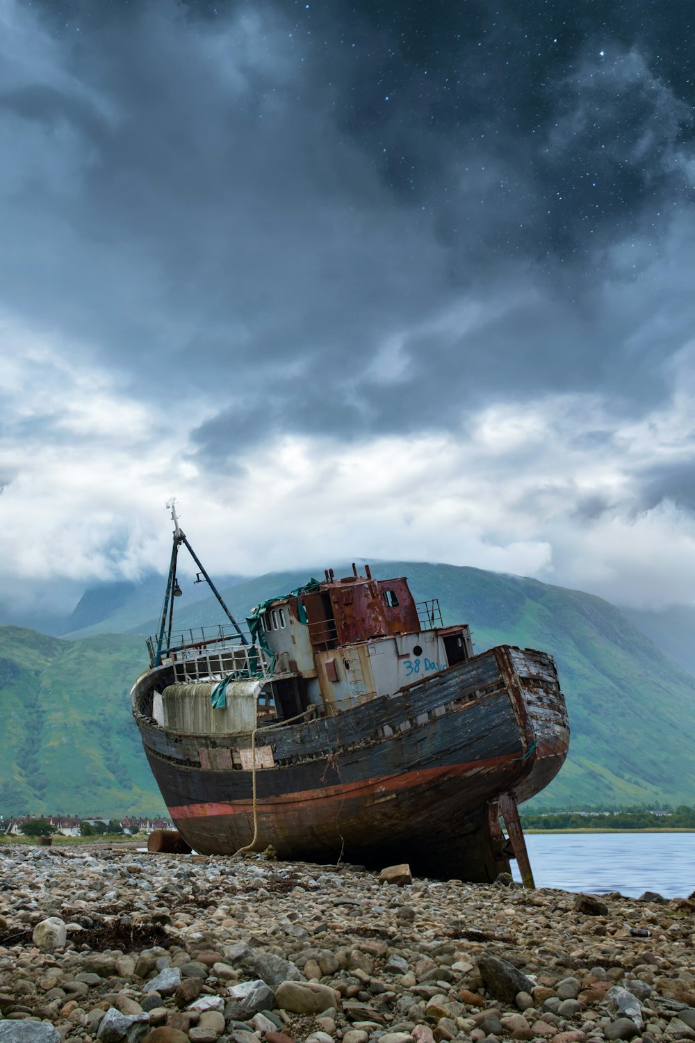 black and red ship on shore