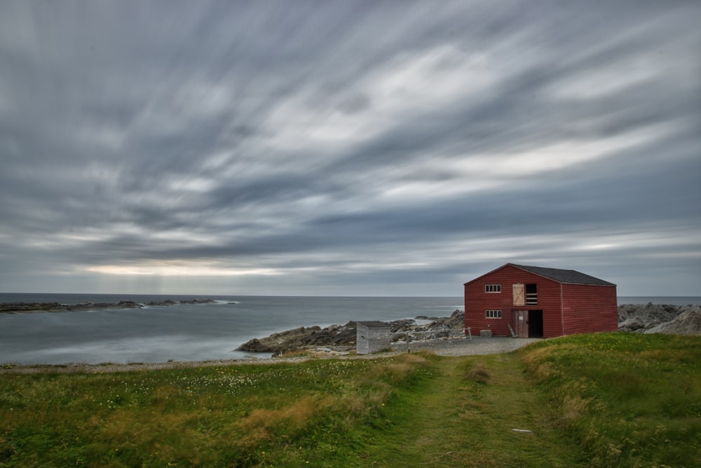 red wooden house near ocean