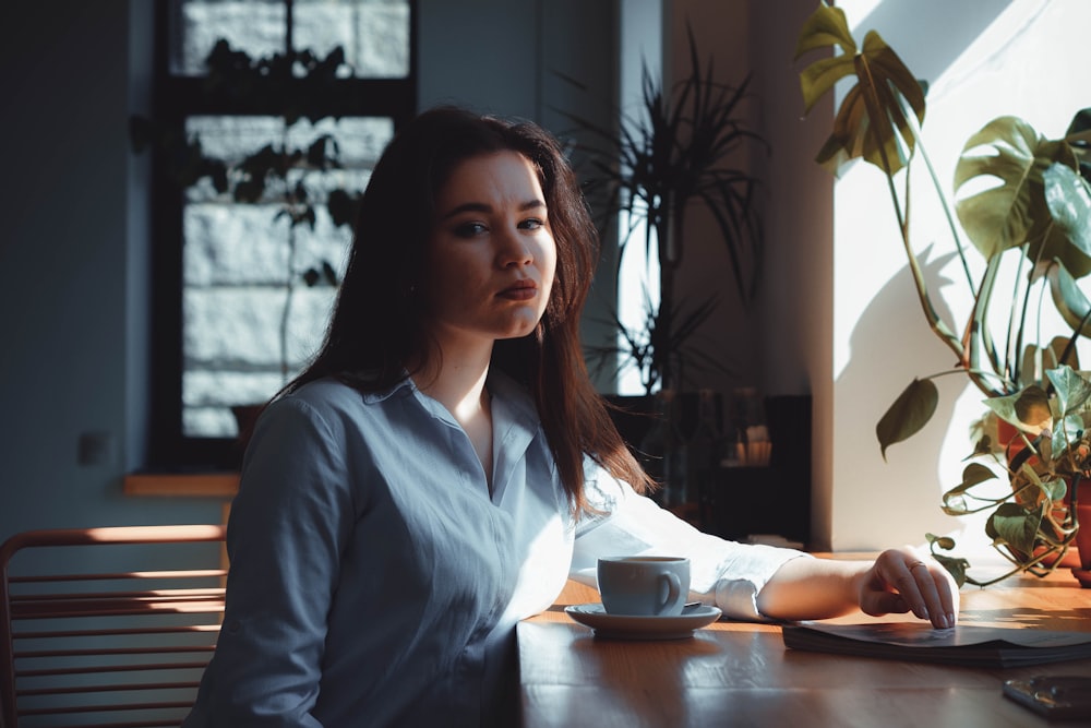 woman sitting beside table