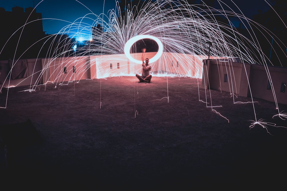 man standing on surface in steel wool photography