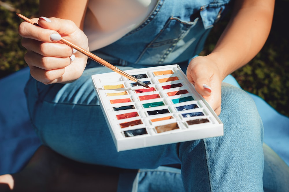 woman holding paint brush and paint palette