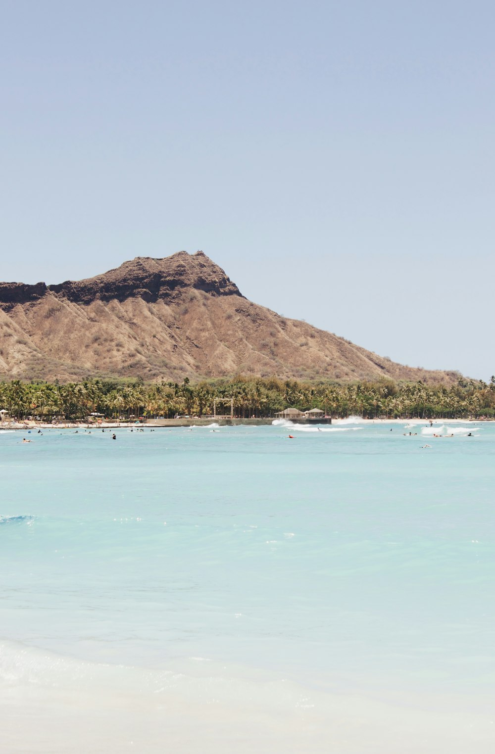 a large body of water with a mountain in the background