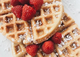 red strawberries on brown waffles