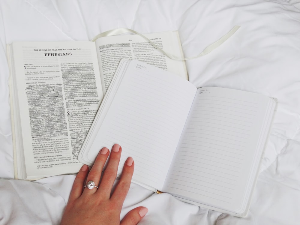 person holding lined book