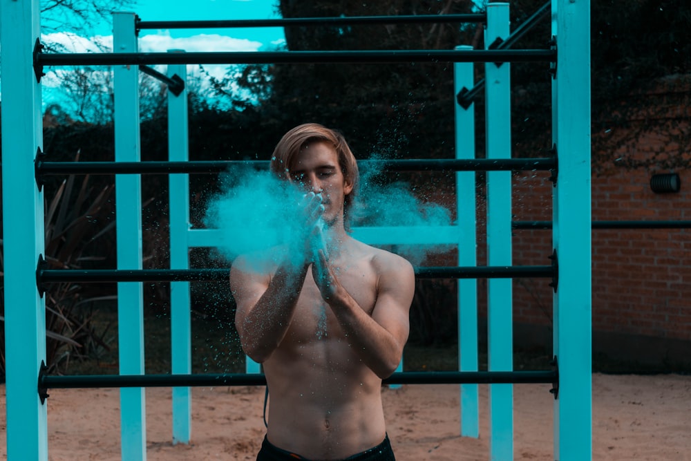 man standing near metal stand