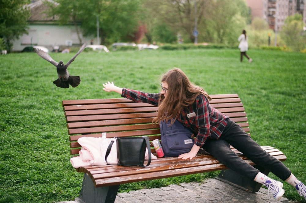 woman reaching for bird