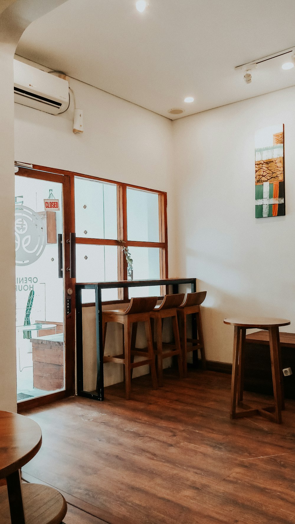 brown wooden chairs near window