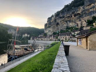 Overhead shot of a riverside village with colorful houses and boats along the shore.