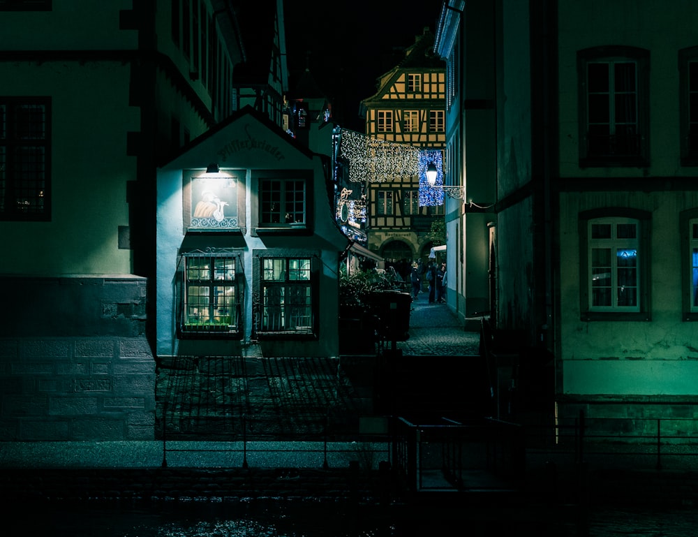 a dark alleyway with a small store at night