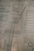 A detailed technical drawing on a slightly worn page, possibly from a book or manual, displaying various mechanical components and sectional views with measurements and annotations, drawn in black ink.