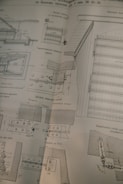 A detailed technical drawing on a slightly worn page, possibly from a book or manual, displaying various mechanical components and sectional views with measurements and annotations, drawn in black ink.