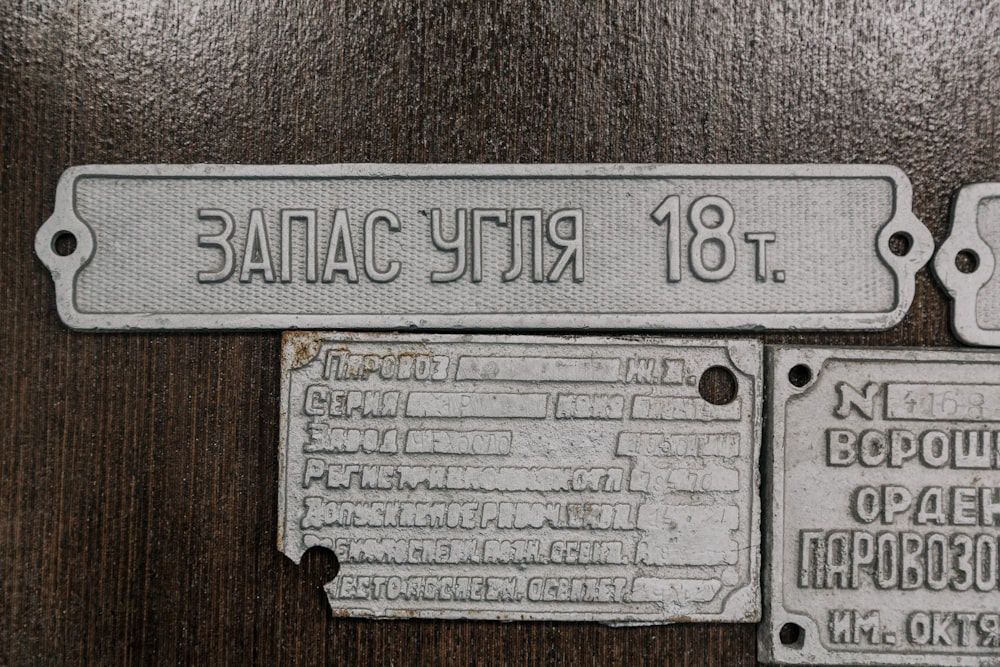 a close up of two metal tags on a table