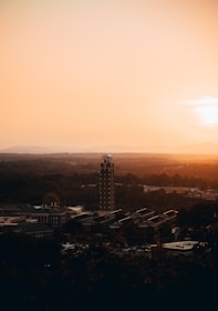 The college building at sunset, warmly lit against the evening sky.