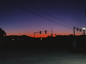 A quiet street corner in Mumbai at dusk, shadows stretching across textured walls.