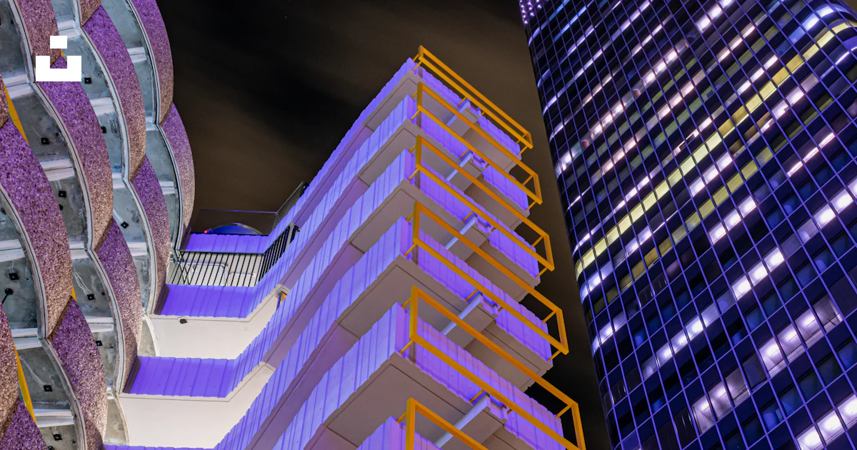 Low-angle photography of white concrete building and curtain wall high ...