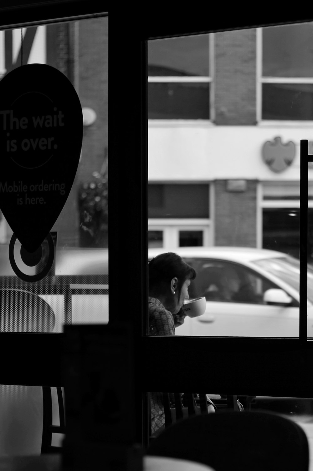 a man sitting at a table in front of a window