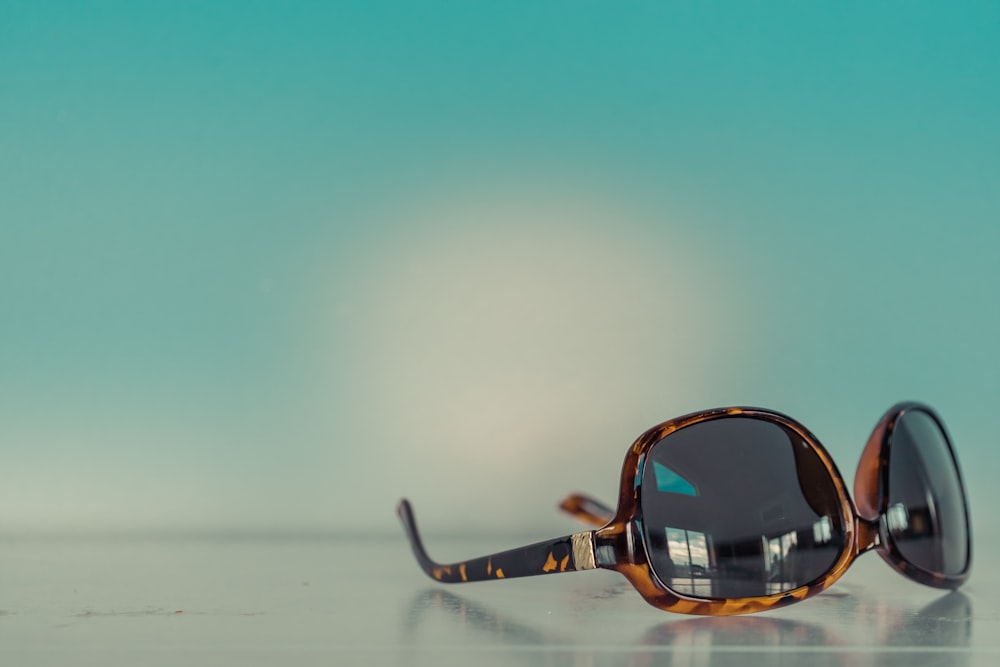 macro photography of brown framed sunglasses