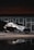 A luxurious executive vehicle parked in front of a modern office building.