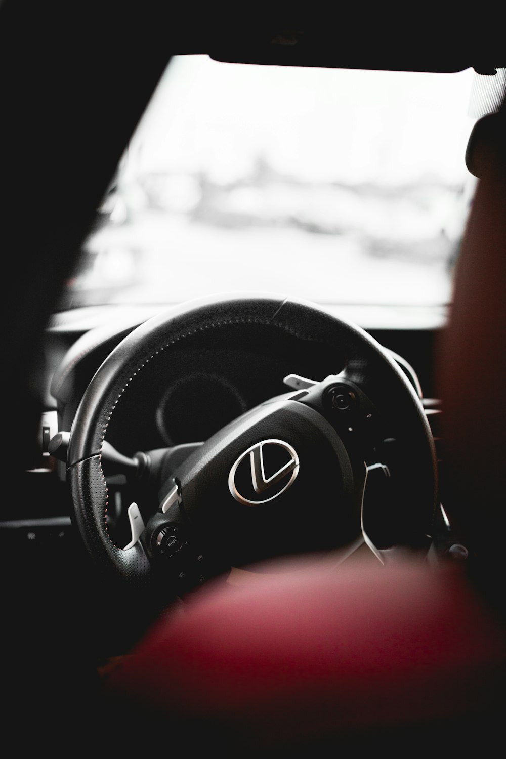 selective focus photography of black Lexus steering wheel
