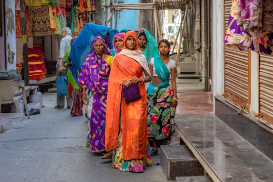 standing women wearing sari dress in Udaipur India