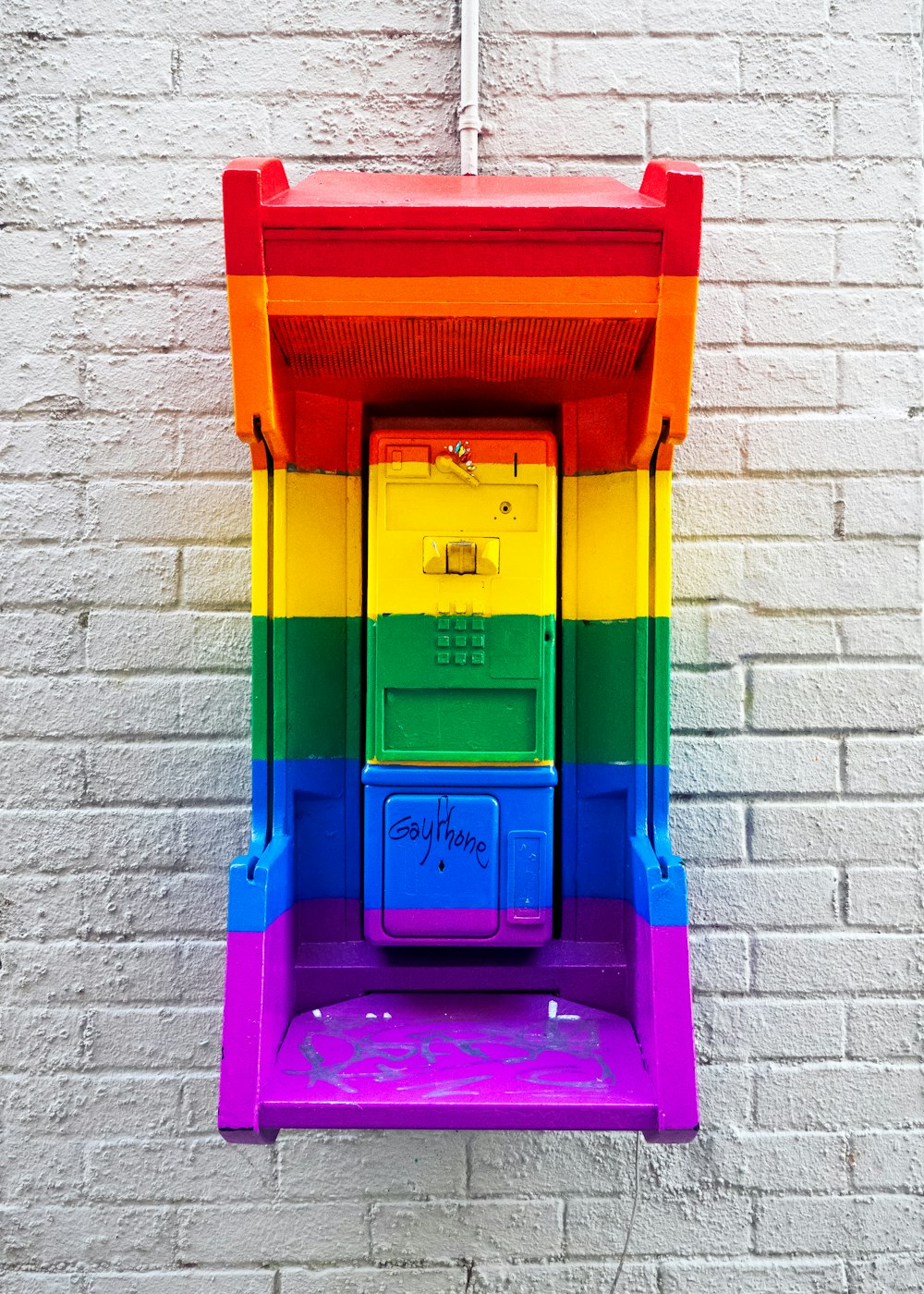a multicolored box on the side of a building