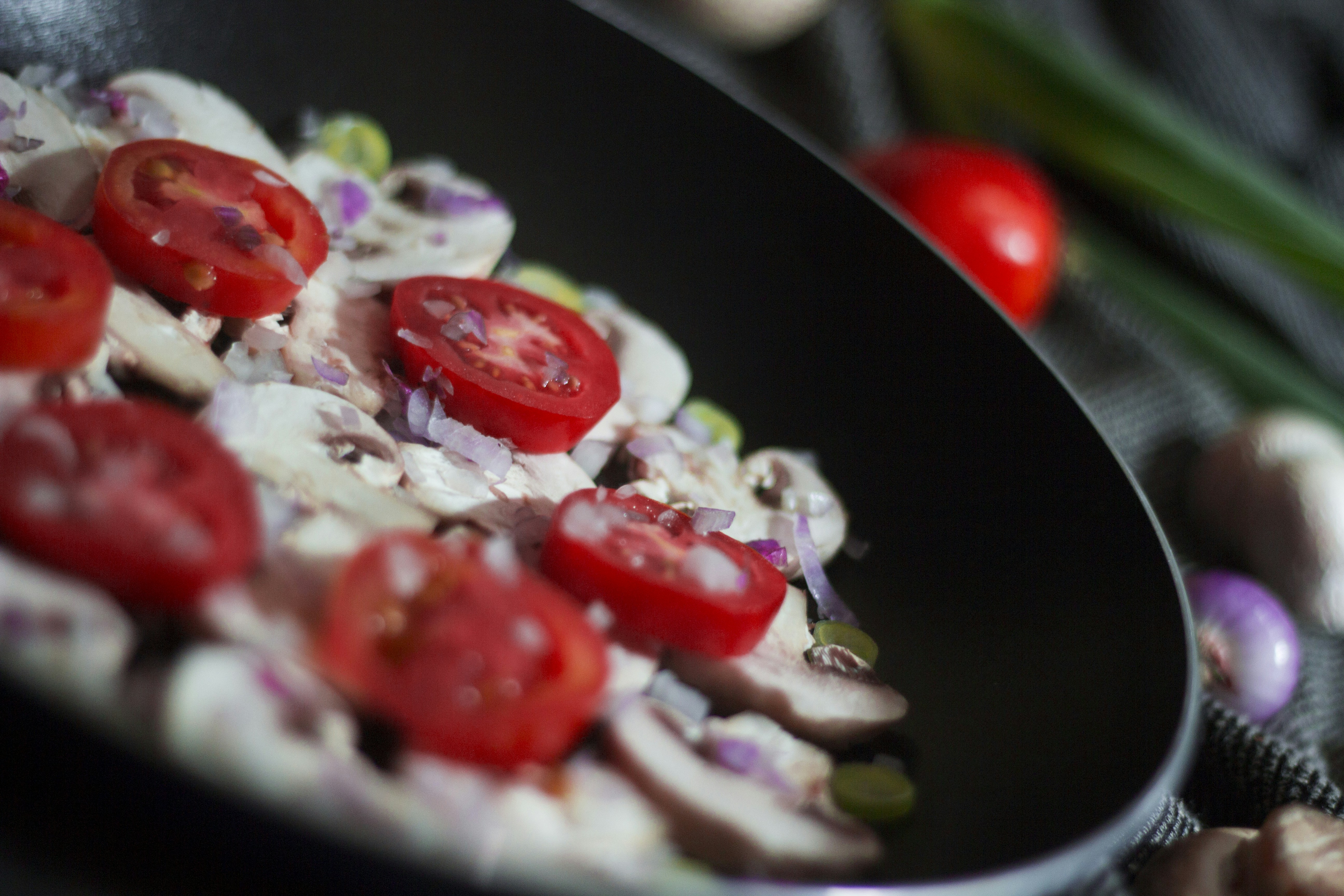 mushroom and tomatoes on a black bowl