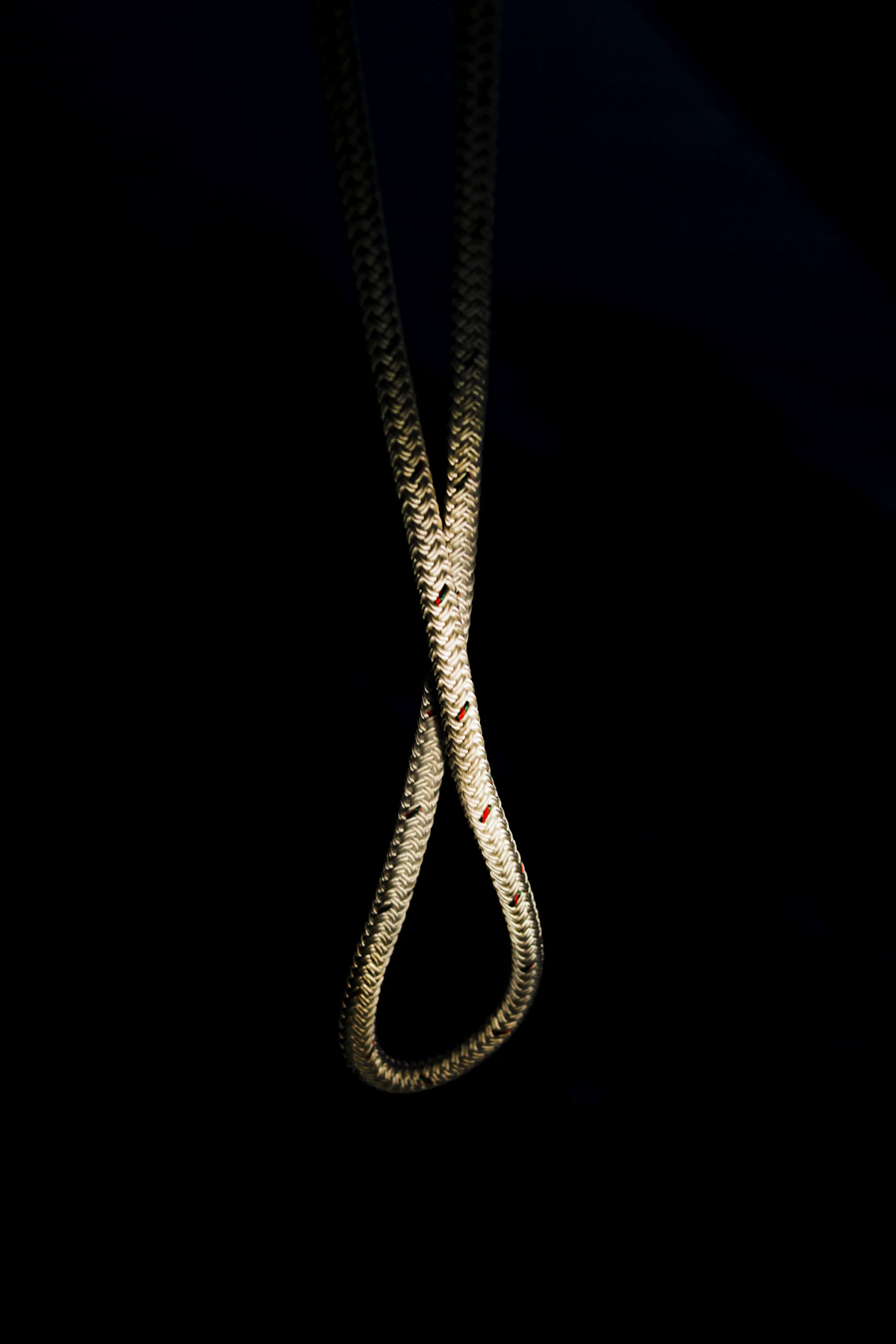 Gold necklace photographed against a black background