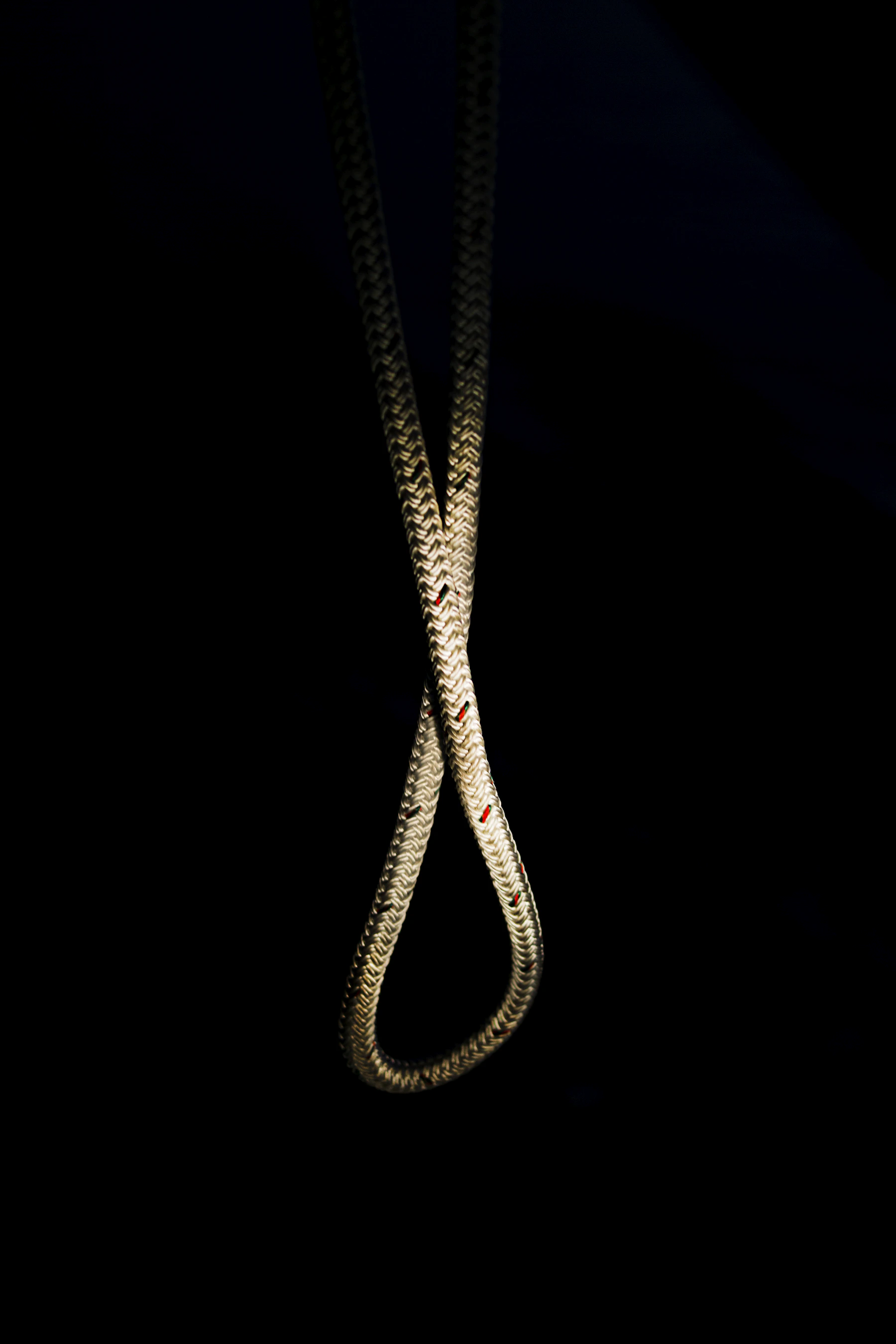 Gold necklace photographed on a dark luxury background