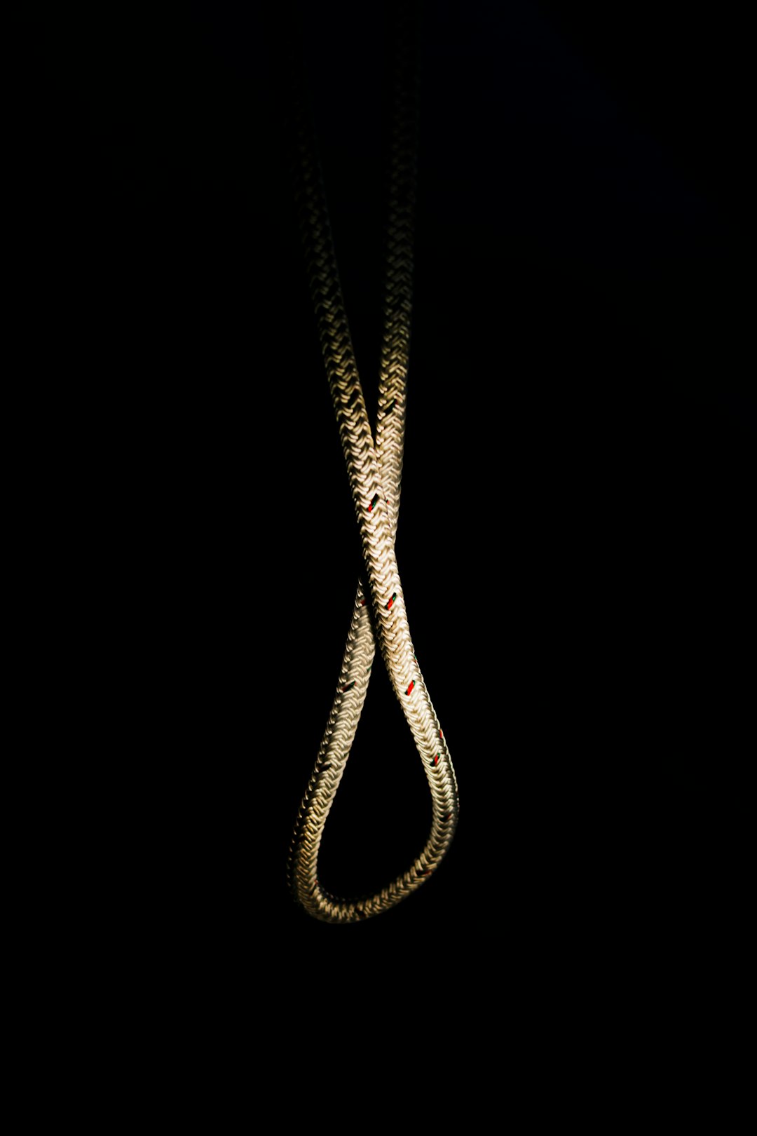 gold-colored necklace on black background