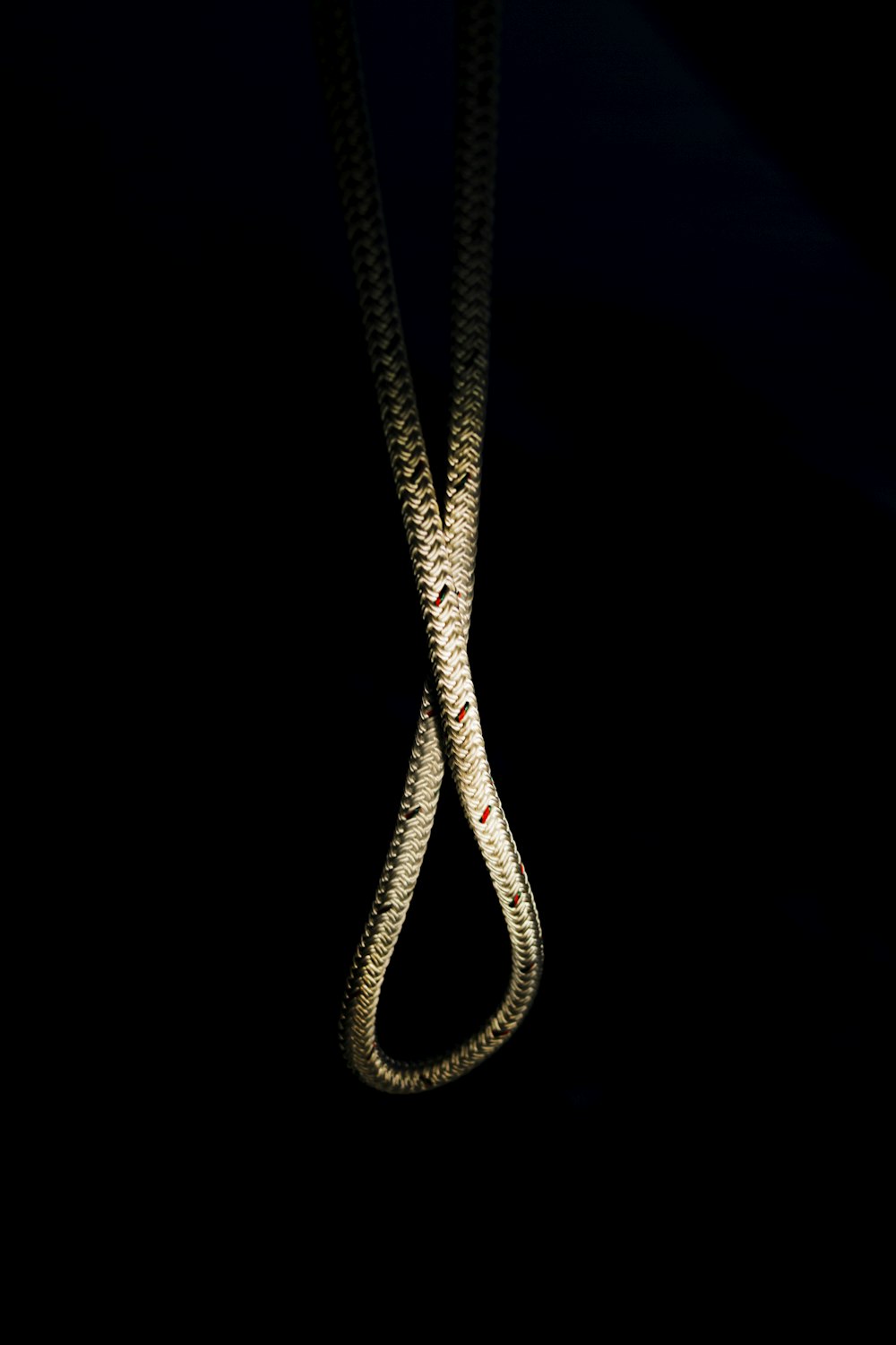 gold-colored necklace on black background