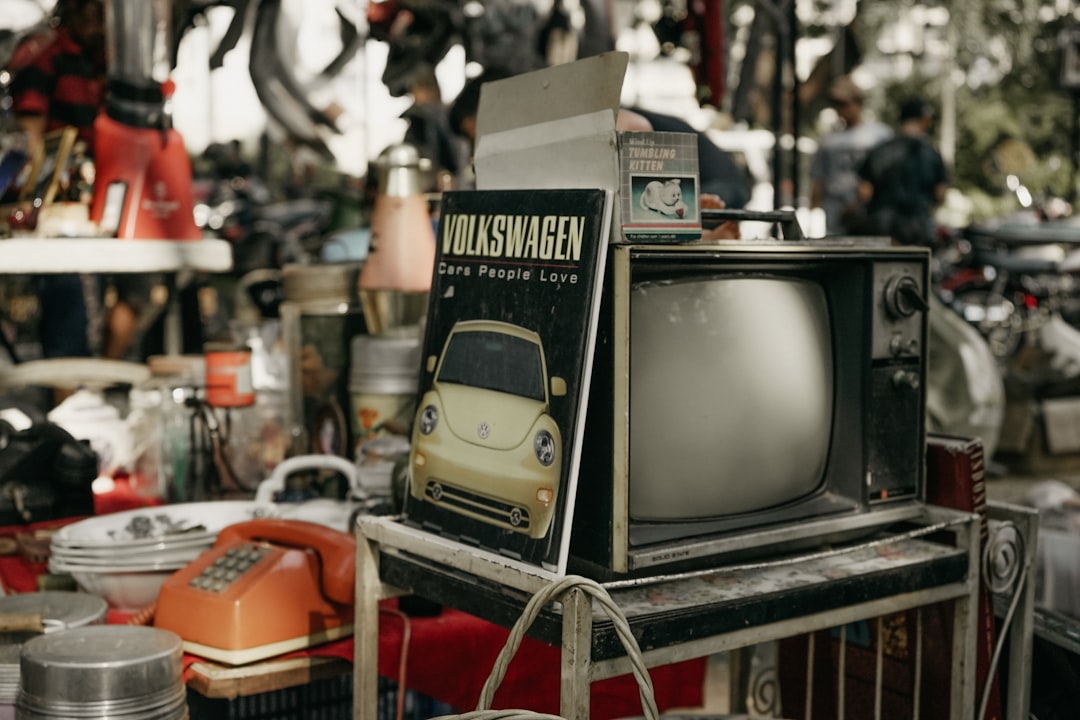 vintage black CRT TV on rack,