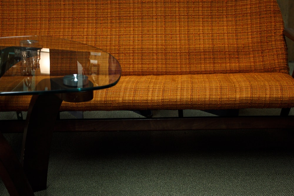 clear glass top table beside sofa