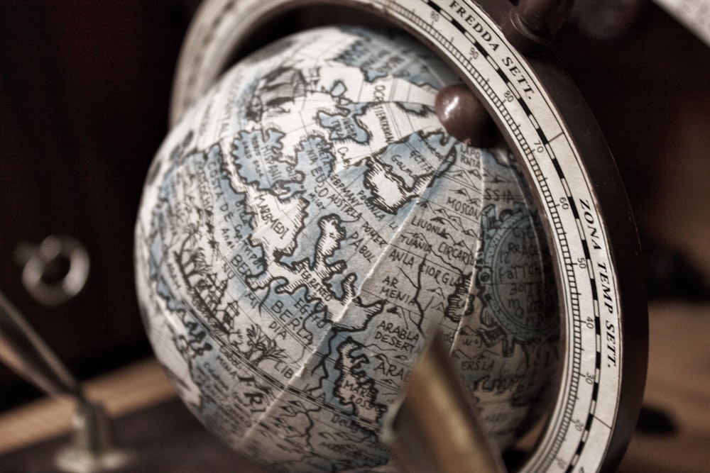 selective focus photography of white and gray desk globe