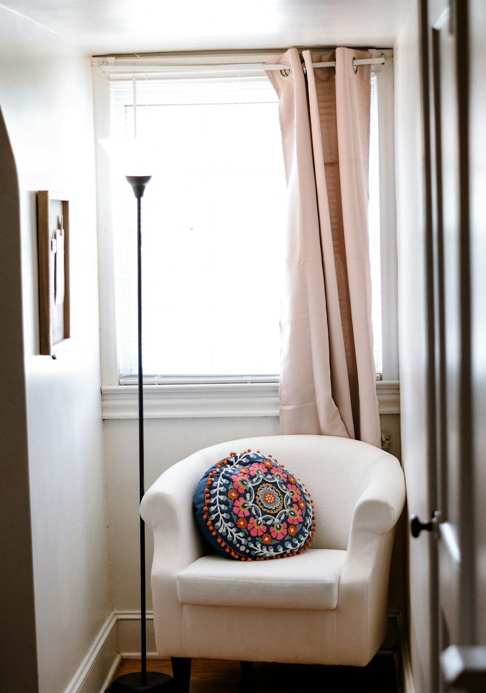 a white chair sitting in front of a window