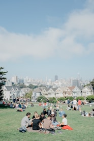 people sitting on grass field during daytime