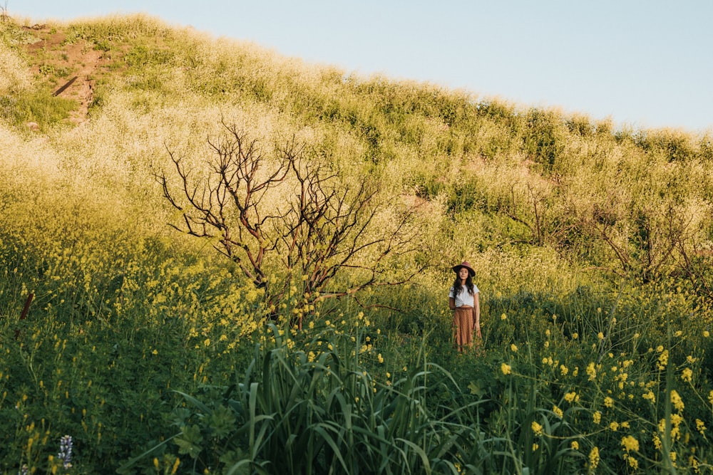 woman wearing white dress standing near bare tree