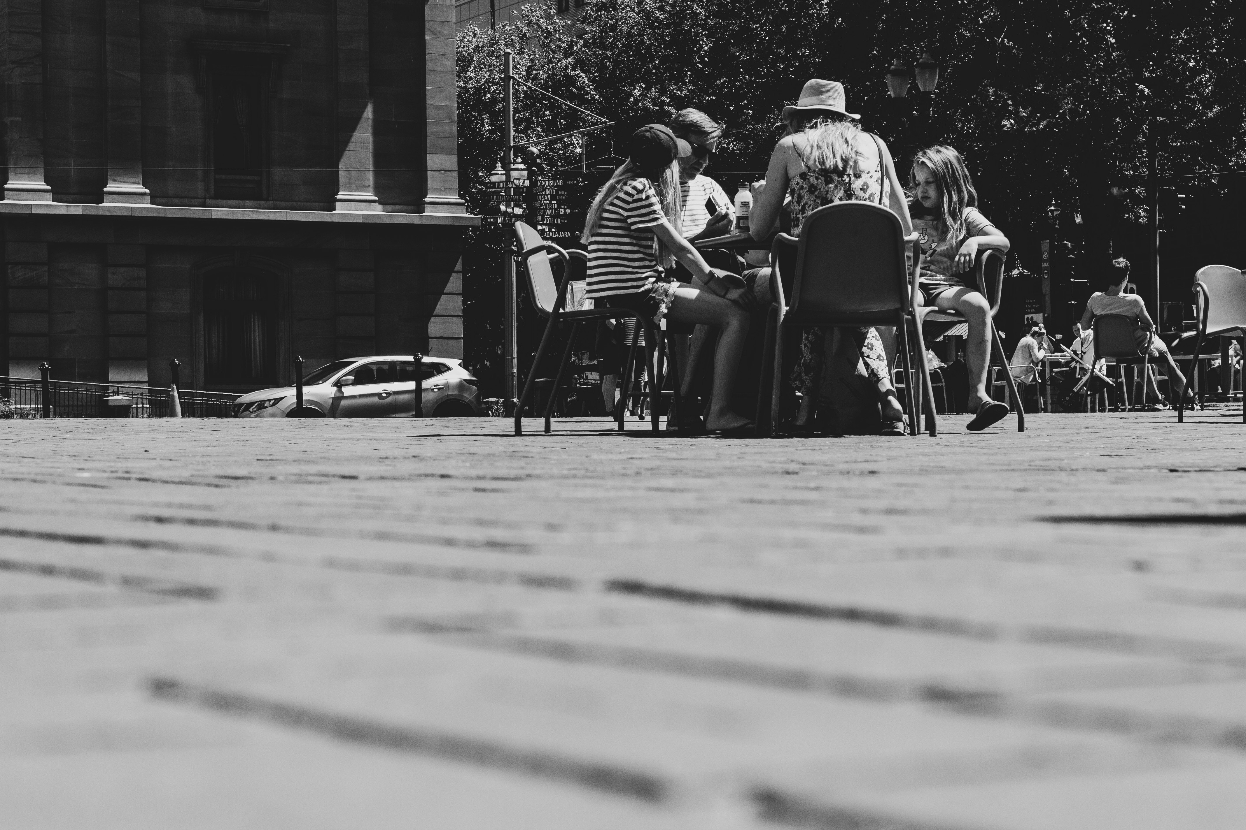 grayscale photo of people sitting at table