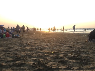 Sunset over Bournemouth beach with families enjoying the sandy shore and calm waves