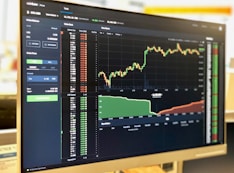 Close-up of a computer screen showing a simple, clean trading interface with charts.
