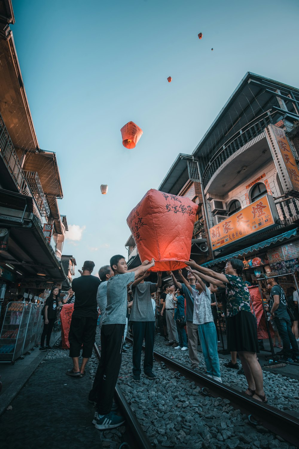 unknown persons holding red paper lantern outdoors