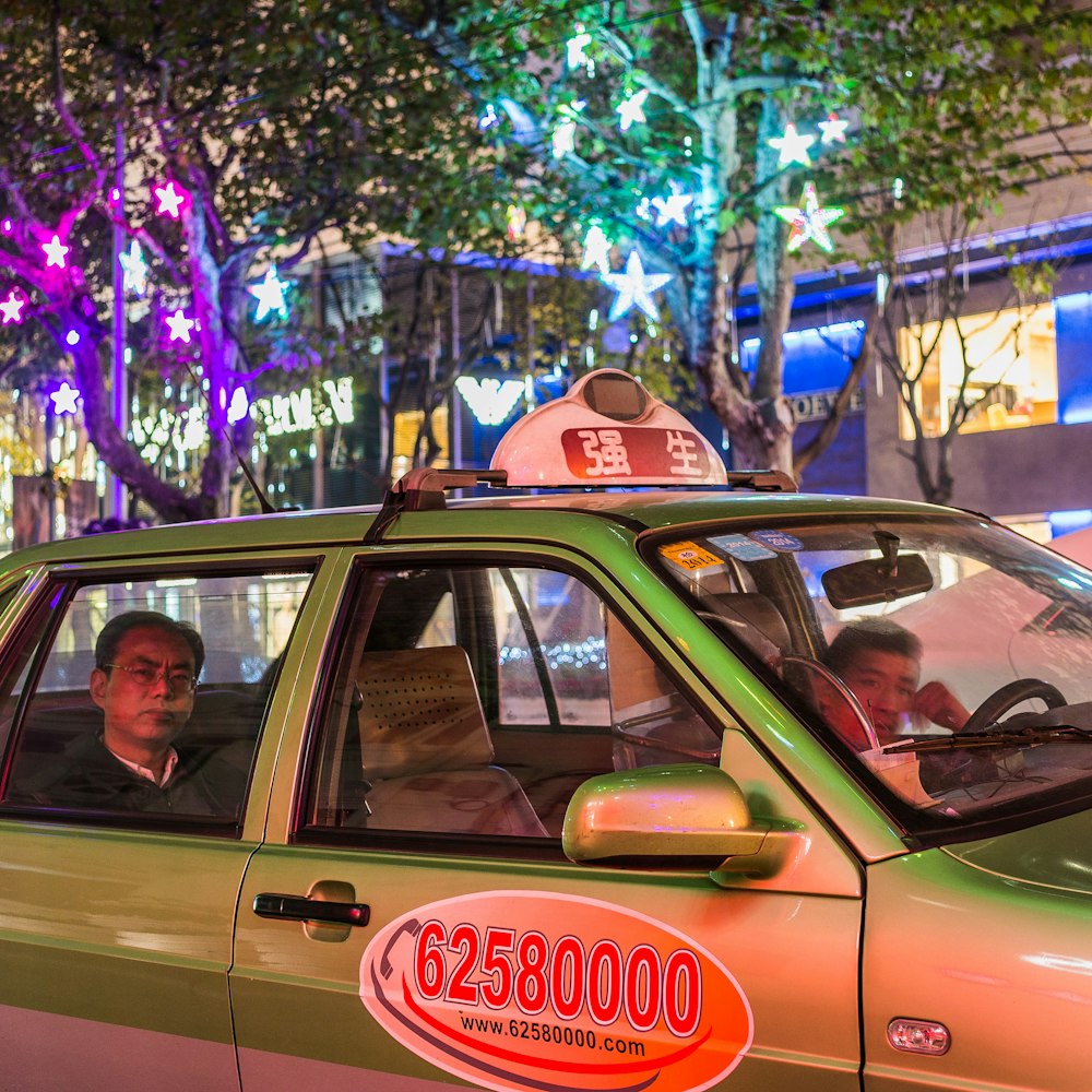 unknown persons riding on green car