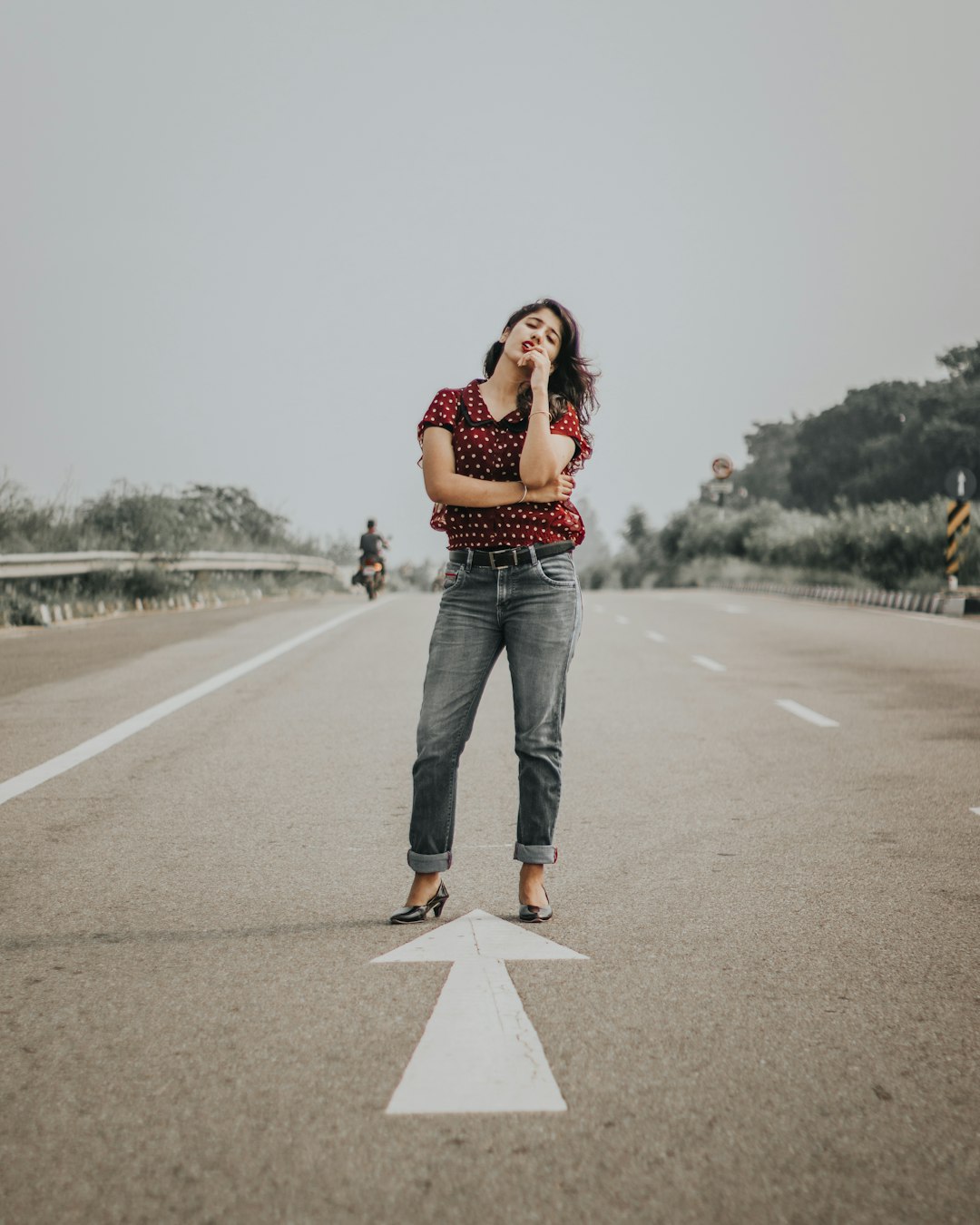 woman standing between road during daytime