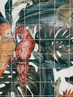 A vibrant portrait of a supporter surrounded by lush tropical foliage and colorful birds.