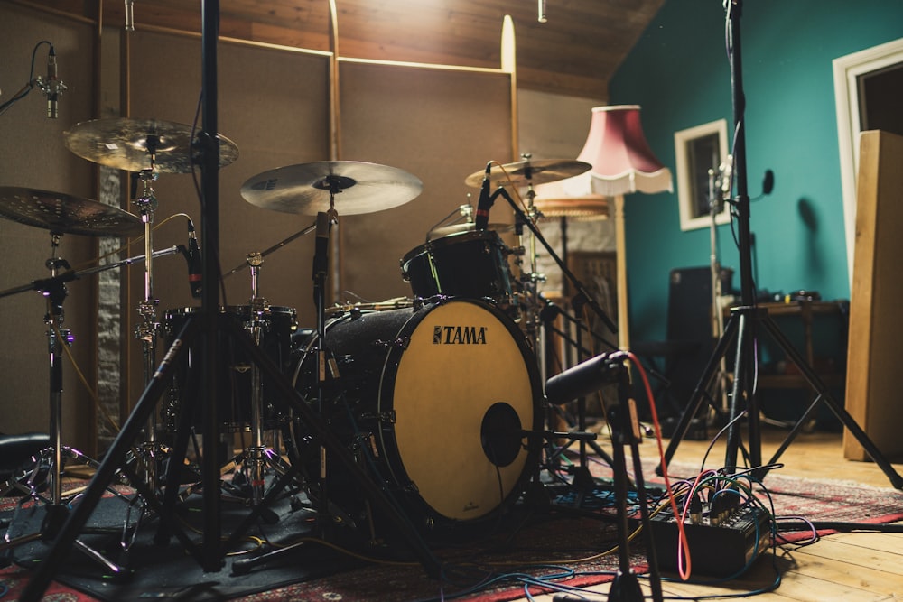 black and white Tama drum set on red and black carpet